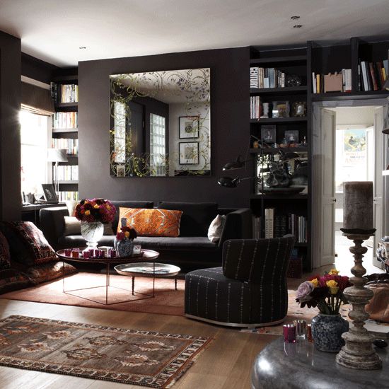 22-dark-living-room-with-black-walls-colorful-accessories-and-various-textiles
